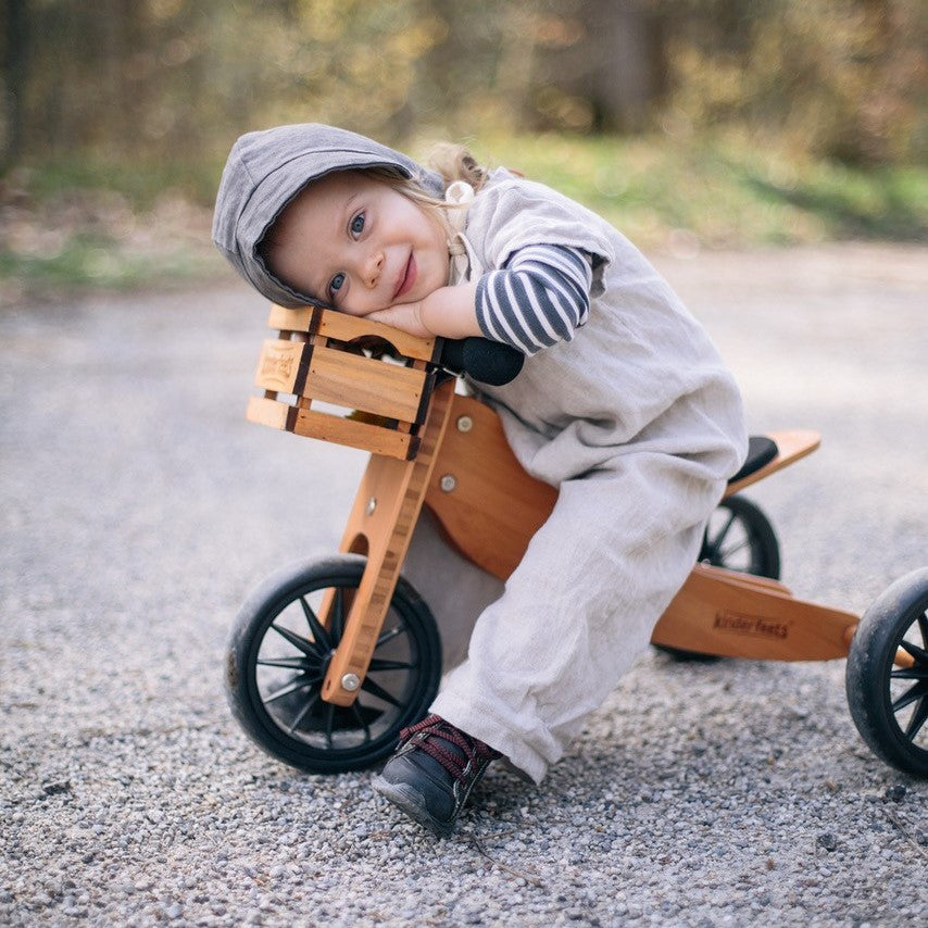 Kinderfeets wooden crate used as a balance bike storage container, featuring a natural wood finish and sturdy construction.