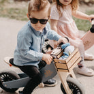 Kinderfeets wooden balance bike in a natural finish, featuring a sleek design and sturdy wooden frame for young children.