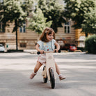Black Kinderfeets balance bike with a sturdy frame and ergonomic handlebars, designed for young children learning to ride.