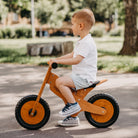 Kinderfeets Balance Bike in natural wood finish, lightweight wooden kids' balance bike for early riding skill development.