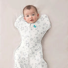 Love to Dream Swaddle Up Bamboo 1.0 TOG with star and moon pattern, soft cream fabric for comfortable baby swaddling.