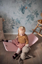 Kinderfeets Kinderboard balance board in rose color, featuring a smooth wooden surface and rounded edges for stability and fun.