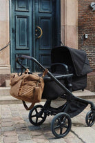 Konges Slojd All You Need Bag in walnut with leather handles, showcasing a stylish and spacious fabric tote for everyday use.