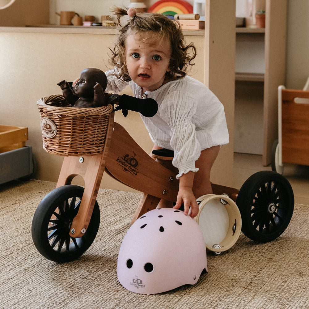 Kinderfeets wicker basket attached to a balance bike, showcasing natural woven design and sturdy construction for outdoor riding.