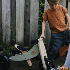 Kinderfeets Tiny Tots Plus slate grey balance bike for toddlers, featuring a sturdy frame and ergonomic design for young children.