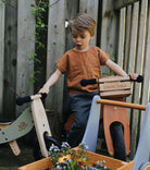 Kinderfeets Tiny Tots Plus balance bike in Silver Sage for young children, featuring a sturdy frame and toddler-friendly design.