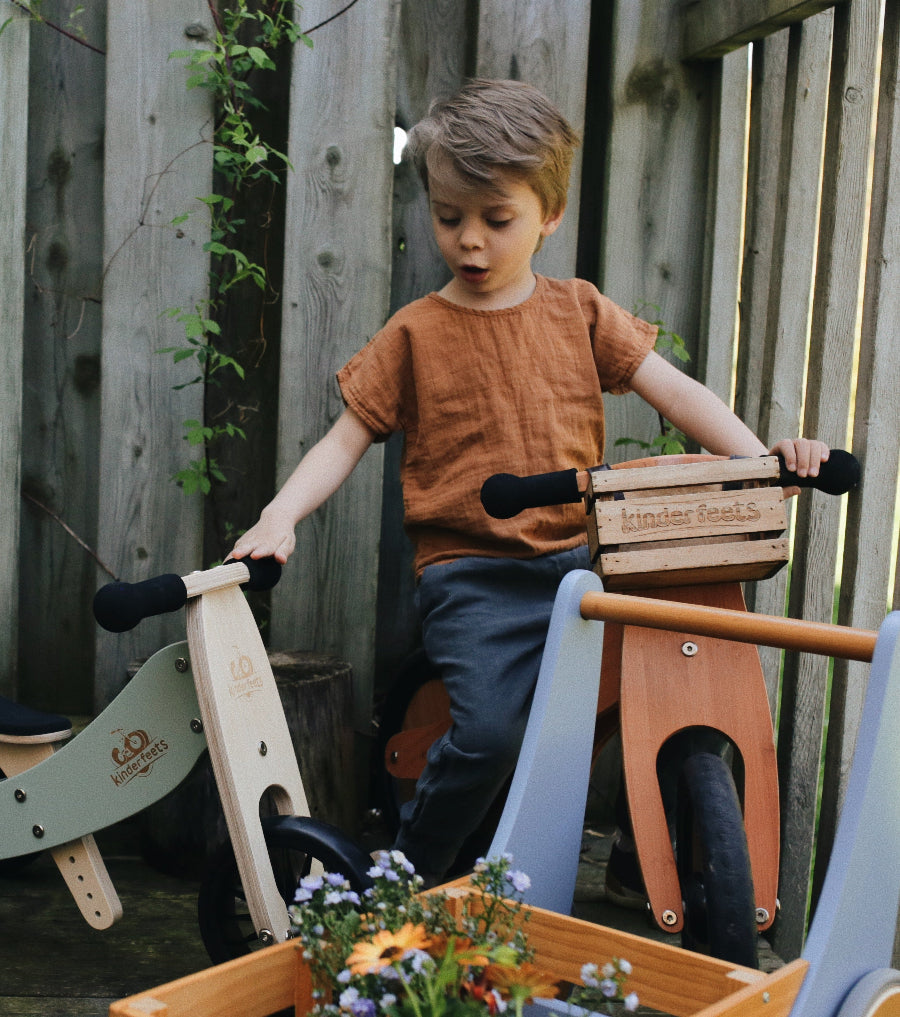 Kinderfeets Tiny Tots Plus balance bike in Silver Sage for young children, featuring a sturdy frame and toddler-friendly design.