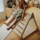 Kinderfeets Pikler Ramp and Slide climbing toy with colorful wooden ramp and slide for children’s play and motor skill development.