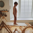 Kinderfeets Pikler climbing toy with a wooden arch and climbing features on a light background.