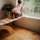 Kinderfeets Pikler ramp and slide climbing toy with wooden construction and colorful steps for toddler outdoor play.