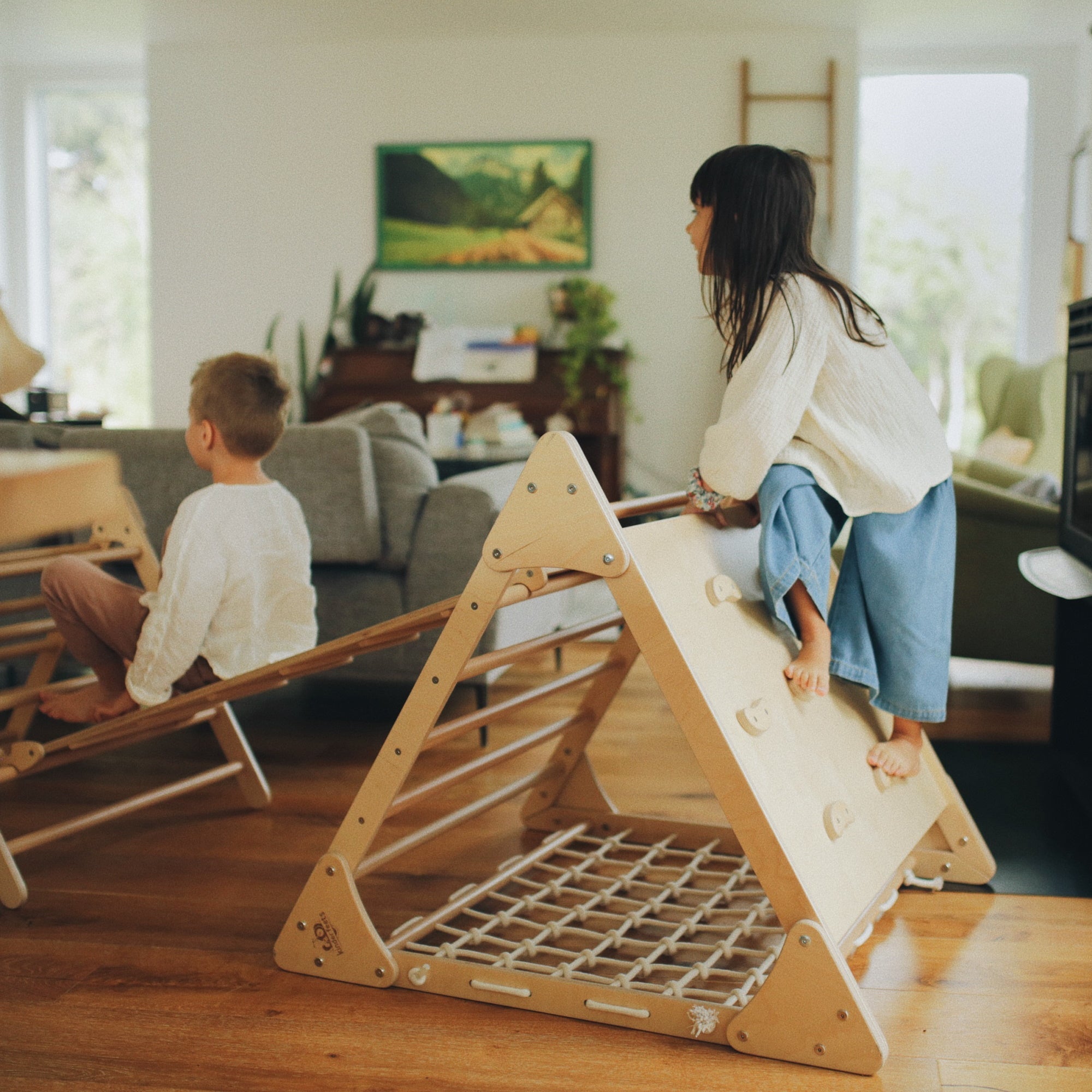 Large Kinderfeets Pikler Triangle climbing toy with wooden frame and colorful rungs for toddler balance and coordination.