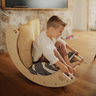 Kinderfeets Pikler rocking and climbing arch toy for kids, made of wood with smooth finish and colorful climbing features.