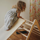 Kinderfeets Pikler Triangle medium climbing toy with natural wood finish, featuring smooth edges and sturdy construction for children.