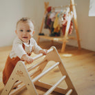 Small Kinderfeets Pikler Triangle climbing toy with wooden frame and colorful rungs for safe, indoor toddler play.