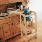 Kinderfeets Pikler Learning Tower in natural wood finish, featuring a sturdy wooden structure for safe climbing and learning at home.