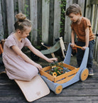 Kinderfeets Cargo Walker wooden toy in mocha color with four wheels and a handle for young children to push and explore.