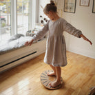 Kinderfeets bamboo balance disc for kids, round and textured, designed for stability and fun indoor or outdoor play.