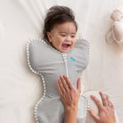 Love To Dream Swaddle Up™ Original 1.0 TOG in grey, a soft fabric swaddle for infants, shown laid out flat.
