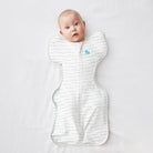 Love to Dream Swaddle Up™ Original 1.0 TOG swaddle in light fabric, shown on a sleeping infant with arms up for easy comfort.
