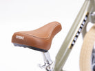 Trybike brown bike seat with chrome stem, designed for kids' bikes and scooters, showing the comfortable saddle and sturdy stem.