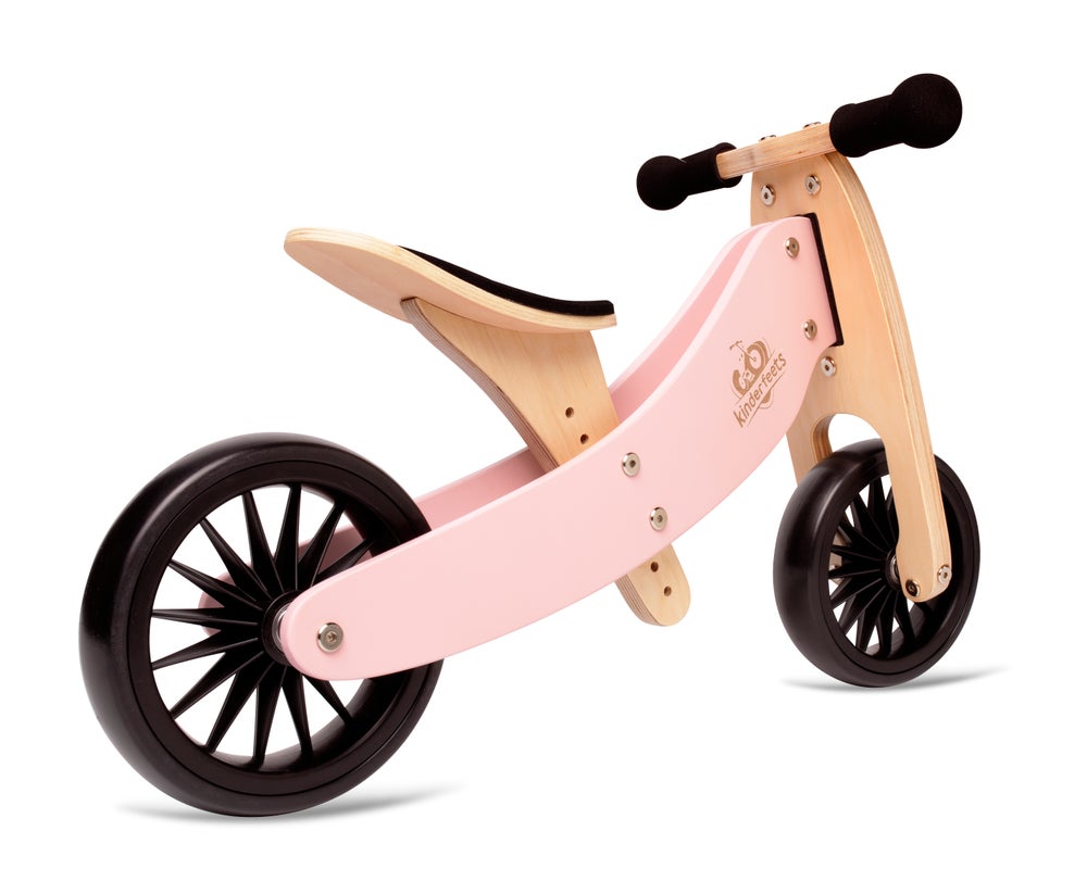 Kinderfeets Tiny Tot Plus pink balance bike for toddlers, featuring a lightweight frame and two wheels for stability.