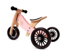 Kinderfeets Tiny Tot Plus pink three-wheel balance bike for toddlers, featuring a sturdy frame and bright rose color.