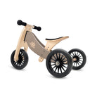 Kinderfeets Tiny Tots Plus slate grey three-wheel balance bike for young children, featuring a sturdy frame and comfortable handlebar.