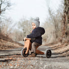 Kinderfeets Tiny Tot lavender balance bike with bamboo frame and simple design, suitable for young children learning to ride.