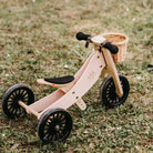 Kinderfeets Tiny Tot Plus rose balance bike for toddlers, featuring a lightweight frame and adjustable handlebars.