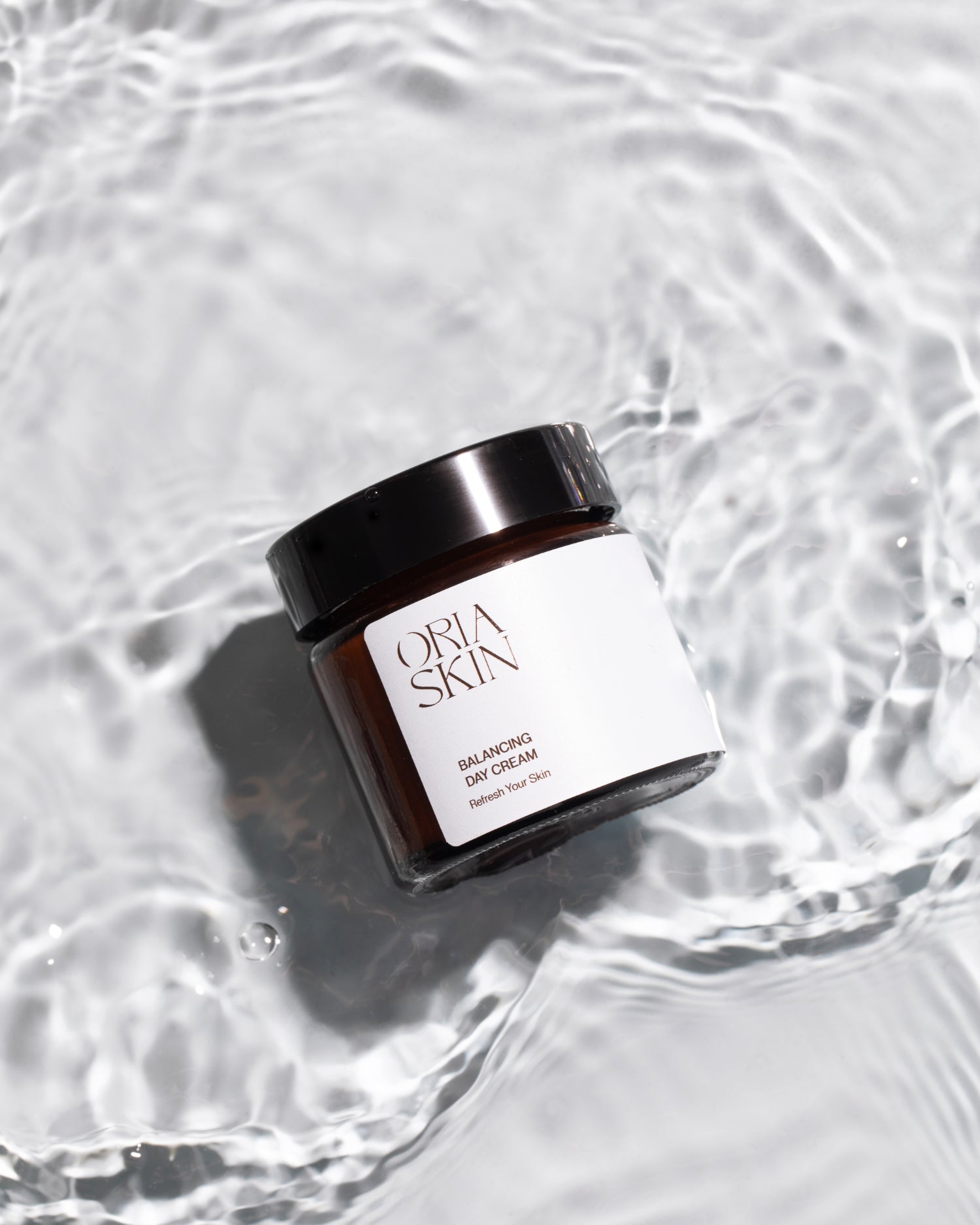 Oria Skin Balancing Day Cream in 65g jar, smooth skincare product with a clean, minimalist design and soft, natural lighting.