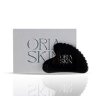 Oria Skin Gua Sha tool made of smooth jade for facial massage and skin lifting.