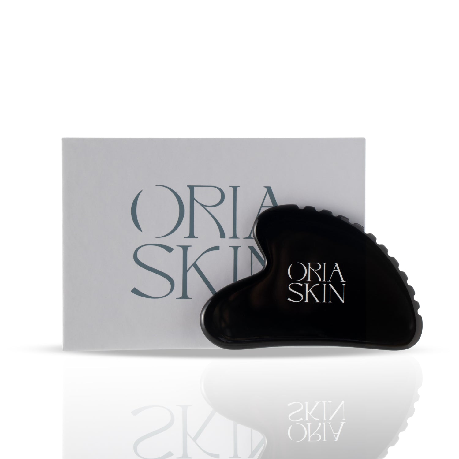 Oria Skin Gua Sha tool made of smooth jade for facial massage and skin lifting.