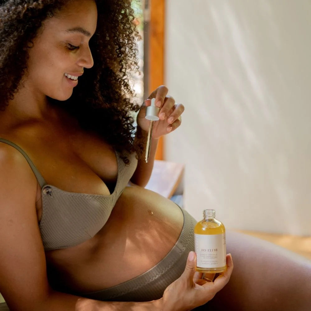 Pure Mama Belly & Body Oil for women, featuring a 145ml bottle of stretch mark and firming skin care cream.