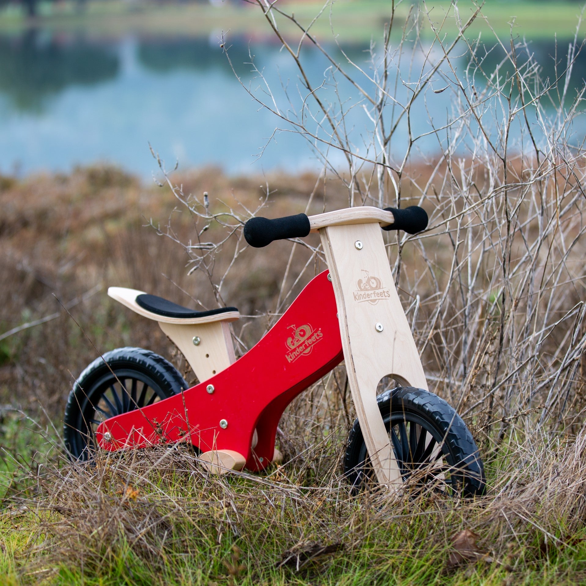 Kinderfeets Cherry Red balance bike for kids with a lightweight frame and adjustable handlebars, perfect for beginner riders.