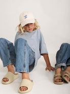 Light-wash denim jeans from Summer and Storm 80 Summer and Storm 80 in a relaxed fit, displayed on a hanger.
