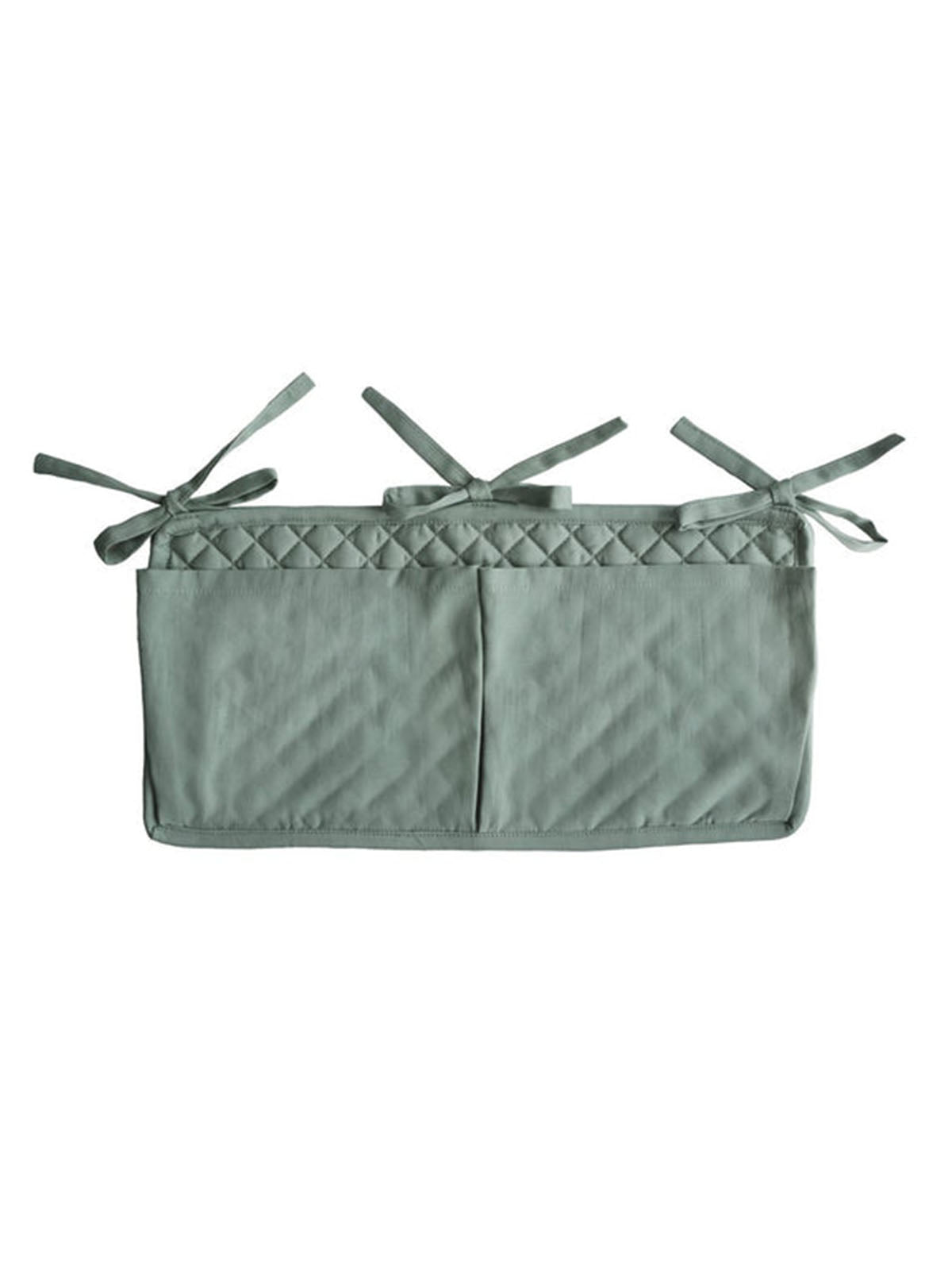 Mushie Roman Green crib pocket attached to a crib, made of soft fabric with a modern design for baby essentials storage.