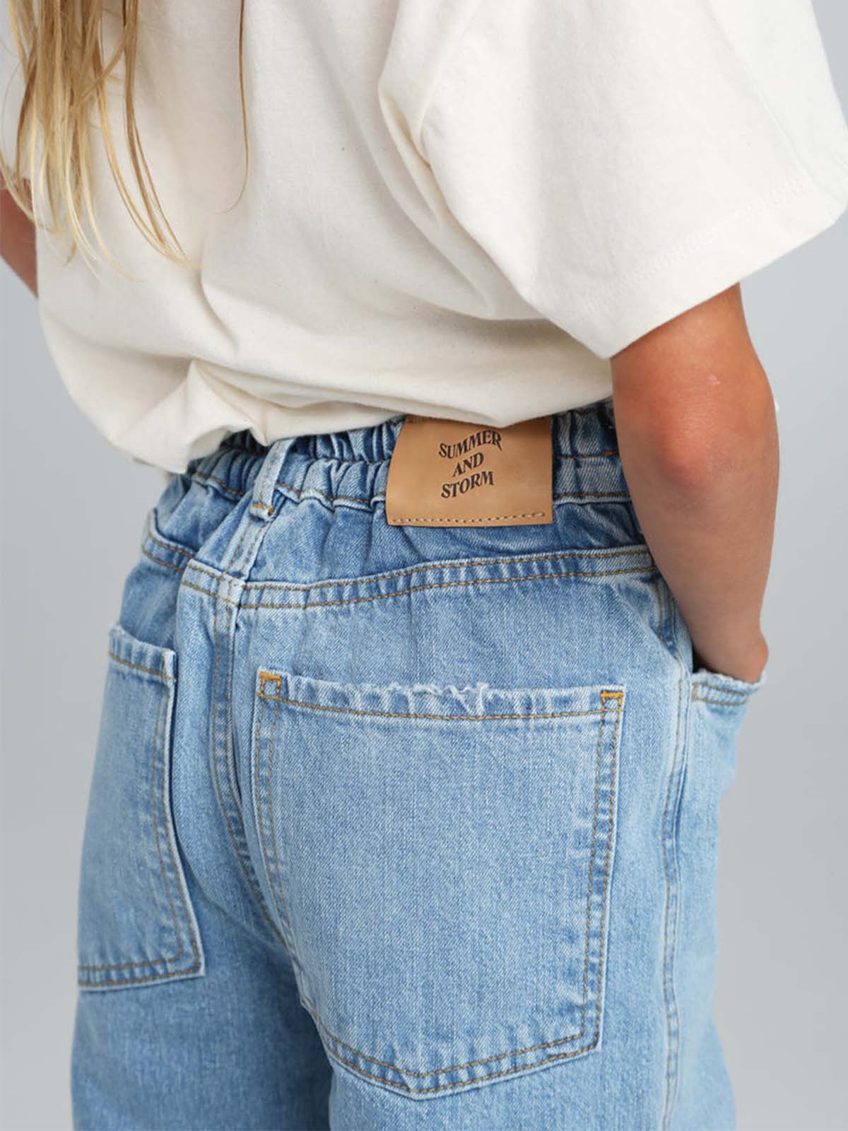 Light-wash Summer and Storm 80 denim jean shown on a model, highlighting classic fit and stylish light-blue denim fabric.
