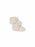 Ivory Quincy Mae baby booties made of soft fabric, featuring a cozy, snug fit for infants, in a natural and gentle style.
