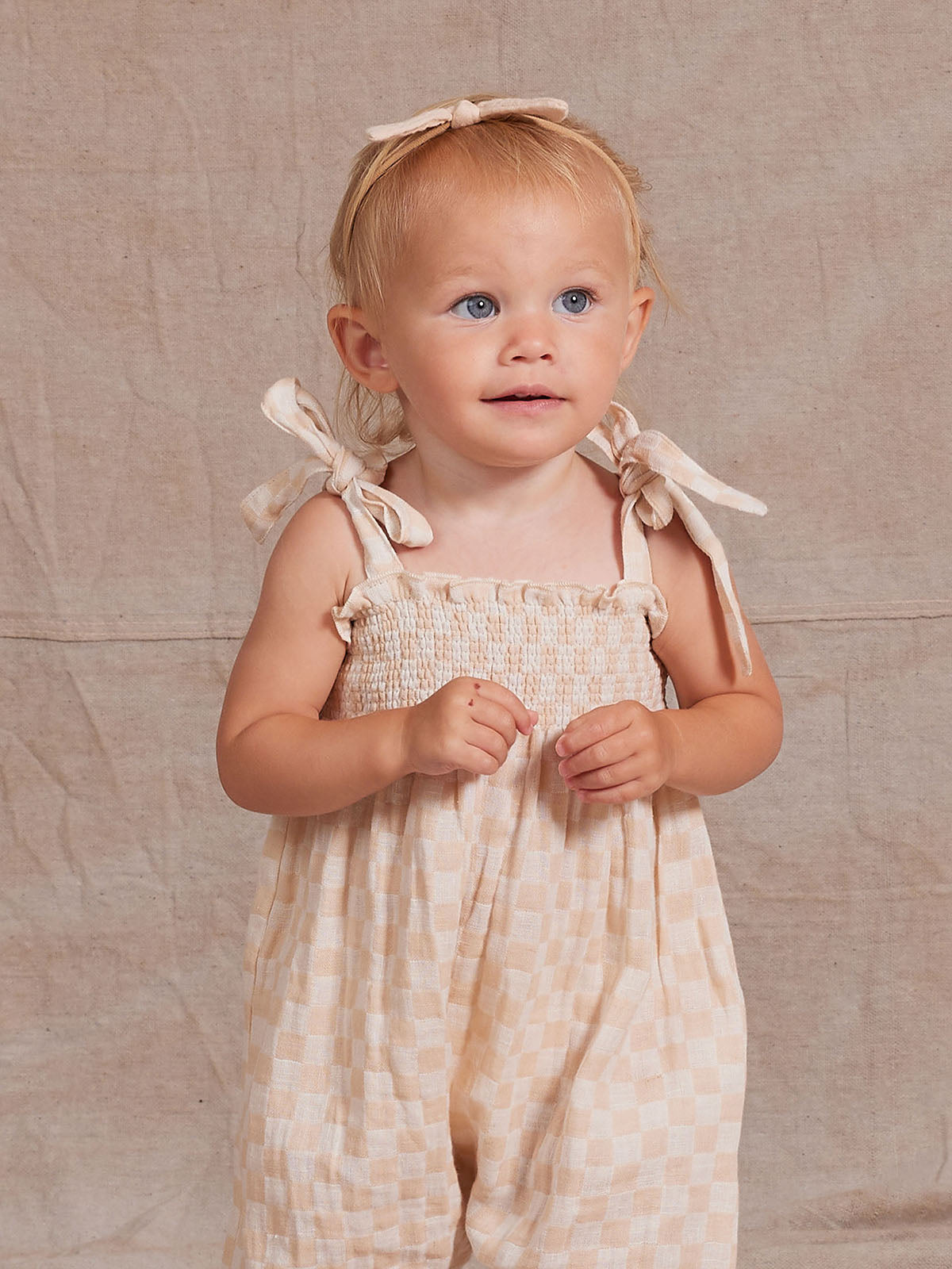 Rylee + Cru Sawyer Shell Check jumpsuit featuring a playful check pattern, long sleeves, and a relaxed fit for kids.