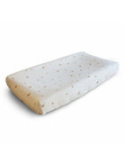 Mushie rainbow changing pad cover with colorful rainbow pattern on a soft fabric change mat.